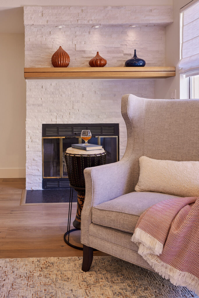 raashi-design-los-altos-ca-interior-design-wood-accents-minimalist-wood-mantel-over-fireplace-upholstered-chair-soft-colors-feng-shui