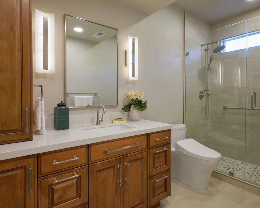 raashi-design-woodside-ca-wood-finishes-bathroom-with-stained-wood-vanity-glass-shower-light-tile-personalized-virtual-interior-design